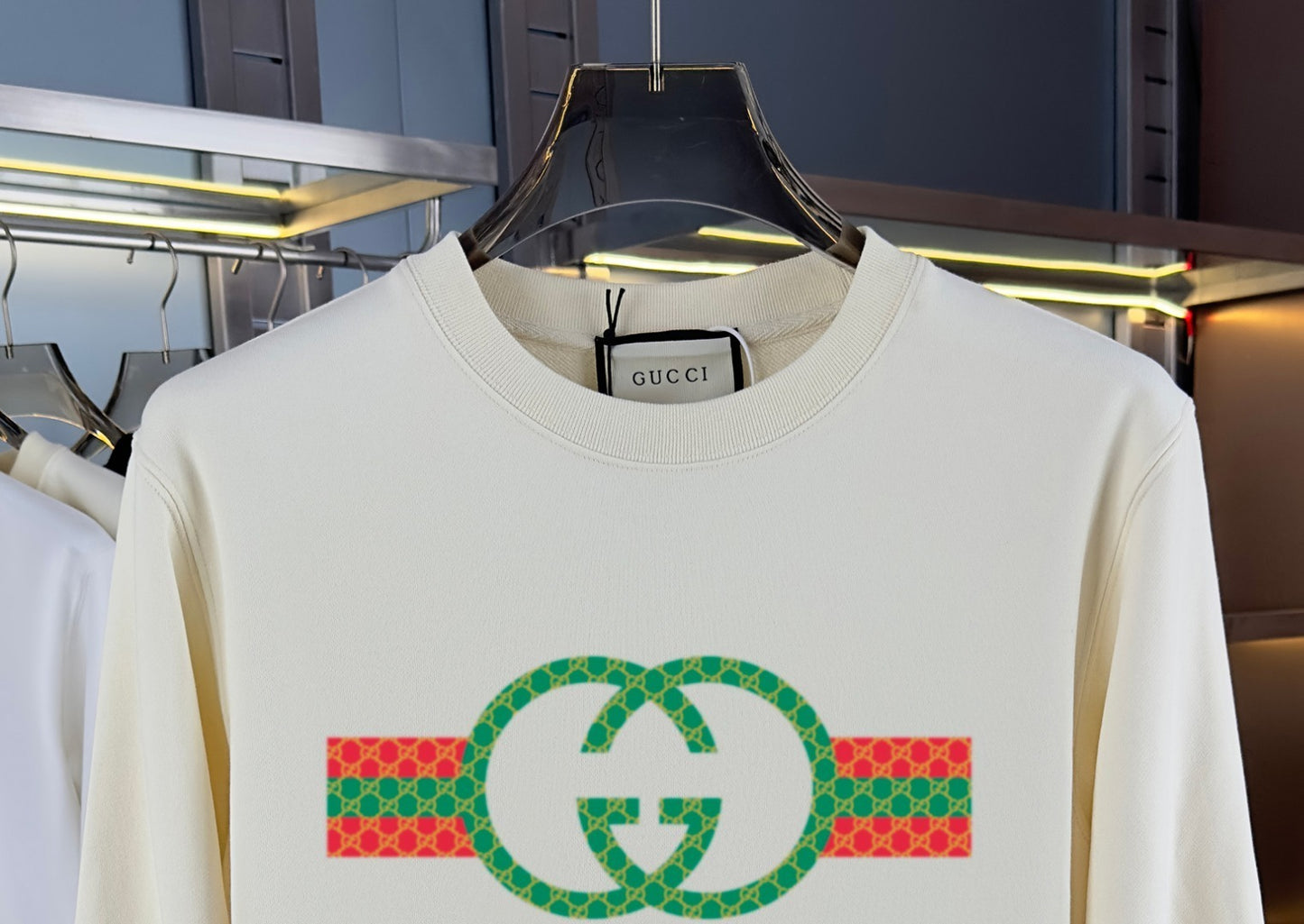 sweatshirt with graphic design on a hanger in a store setting