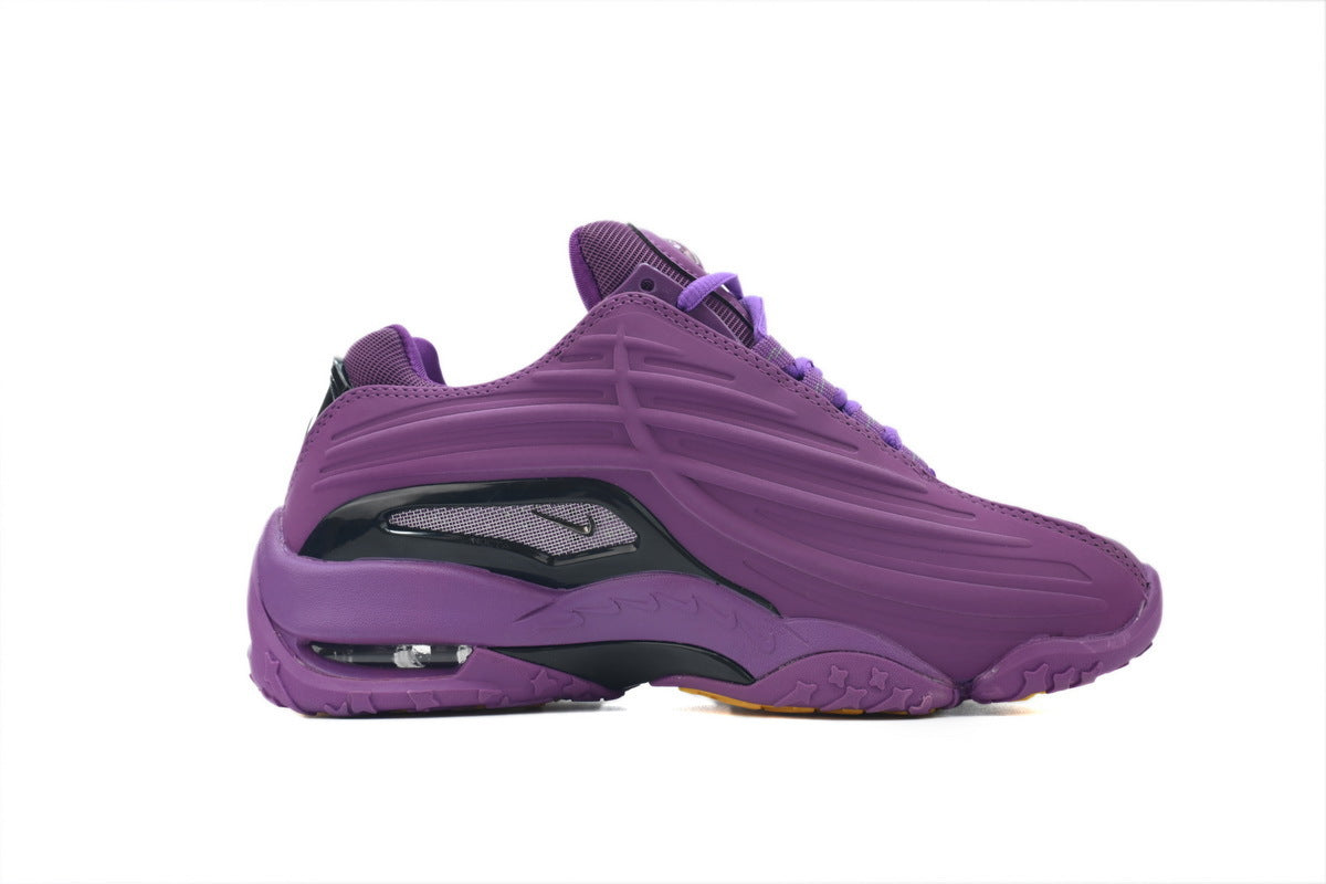 Purple sneaker with black accents on a white background