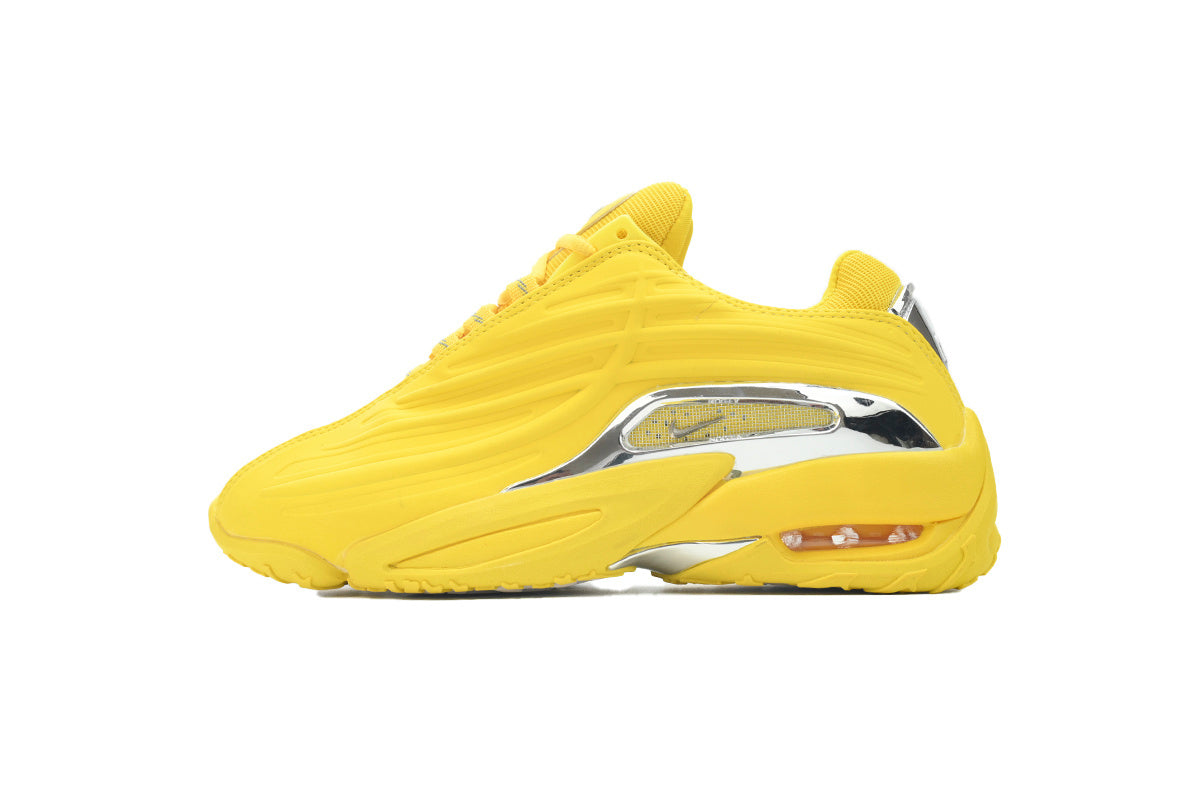 Yellow sneaker with a silver accent on a white background