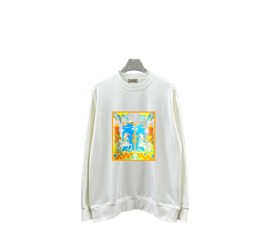 White sweatshirt with colorful graphic design hanging on a gray tiled wall.