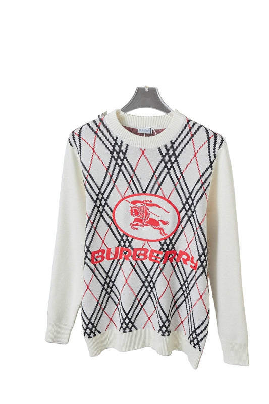 White  sweater with red and black pattern on a metal rack.