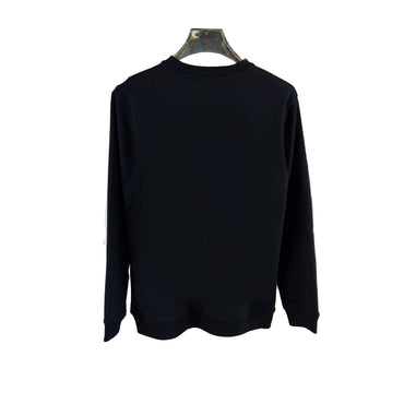 Black sweatshirt on a hanger with a white shirt featuring a colorful graphic in the background.