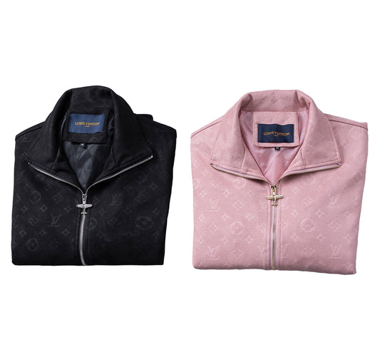 Folded black and pink jackets with on a gray background