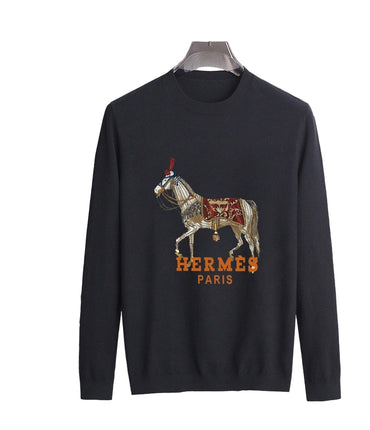 Black sweater with graphic and horse design on a marble background