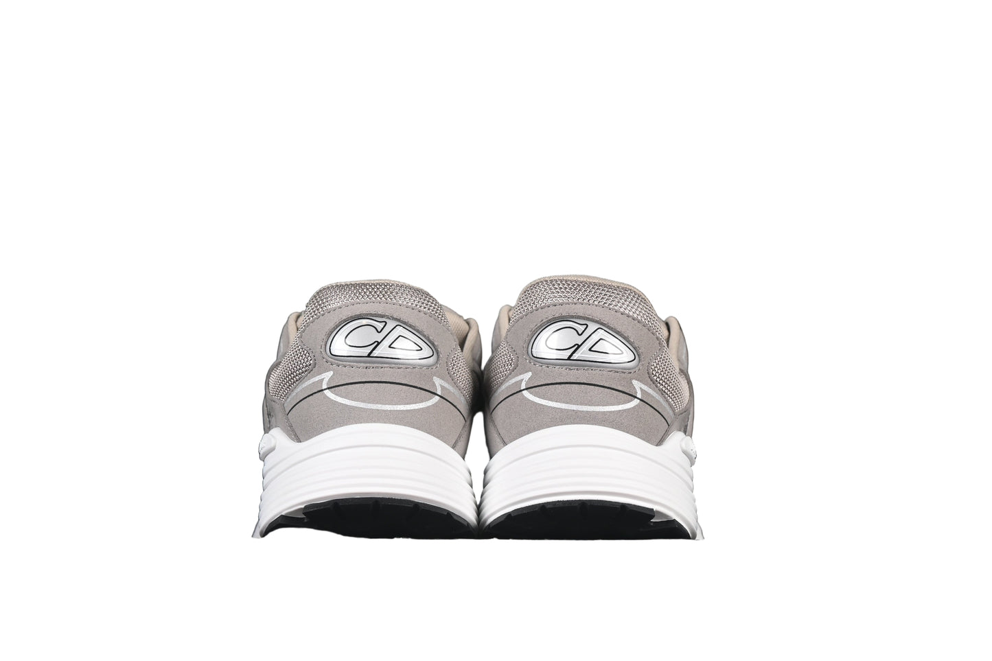 Gray sneakers with white soles on a black background