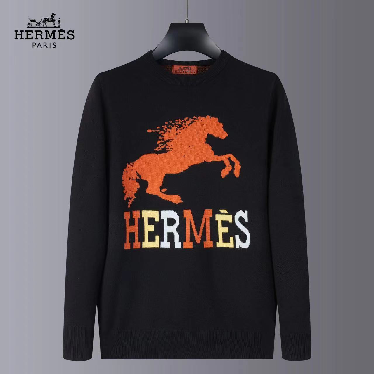 Black sweater with orange horse graphic and 'Hermès' text on a gray background