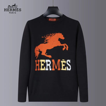 Black sweater with orange horse graphic and 'Hermès' text on a gray background