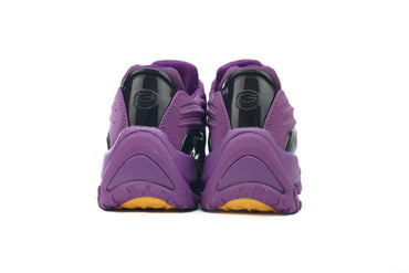 Purple athletic shoes with yellow sole on a white background
