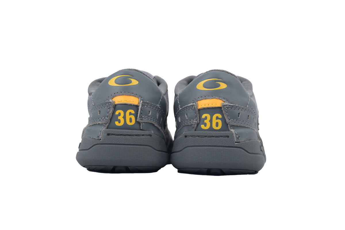 Pair of gray children's shoes with yellow accents on a white background