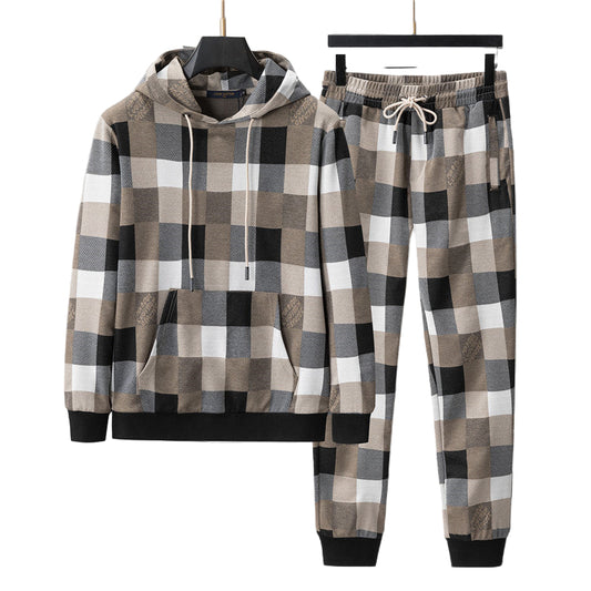 Plaid hoodie and pants set on hangers against a gray background