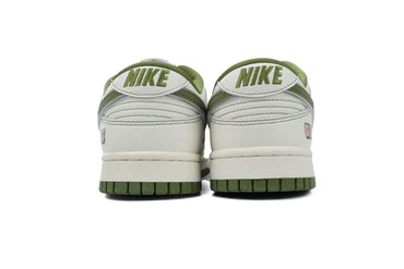 White and green sneakers with a visible  graphic on a white background