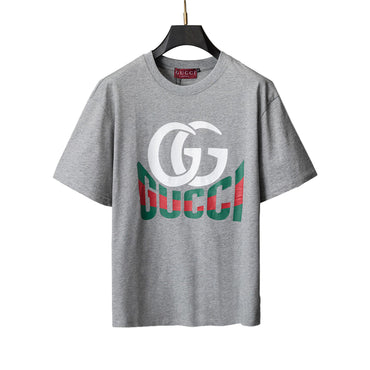 Gray t-shirt on a hanger against a geometric background