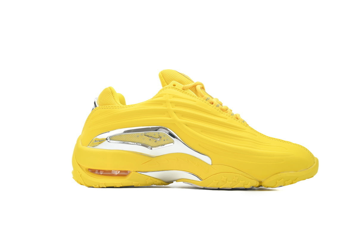 Yellow sneaker with a white sole on a white background