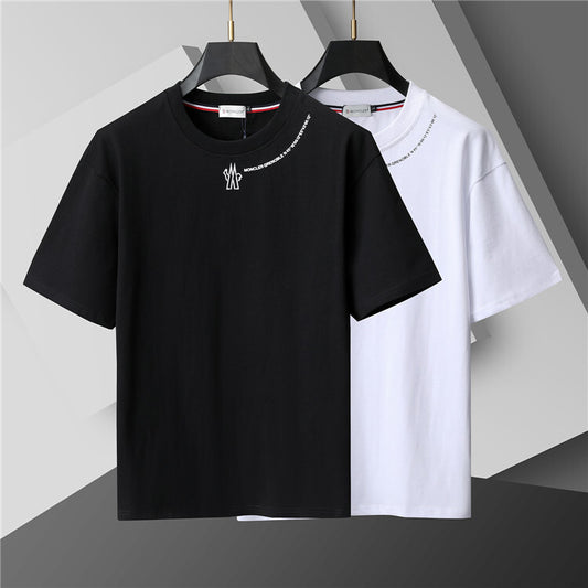 Black and white t-shirts on hangers against a gray background