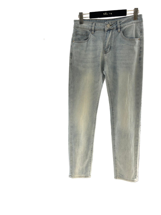 Light gray jeans hanging on a rack with a blurred background