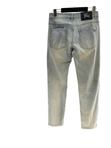 Light blue jeans hanging on a rack with a blurred background