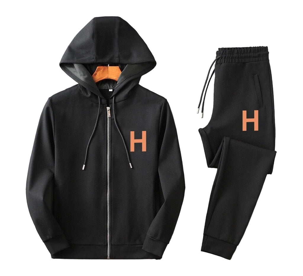 Black hoodie and pants set with orange 'H' graphic on a gray background