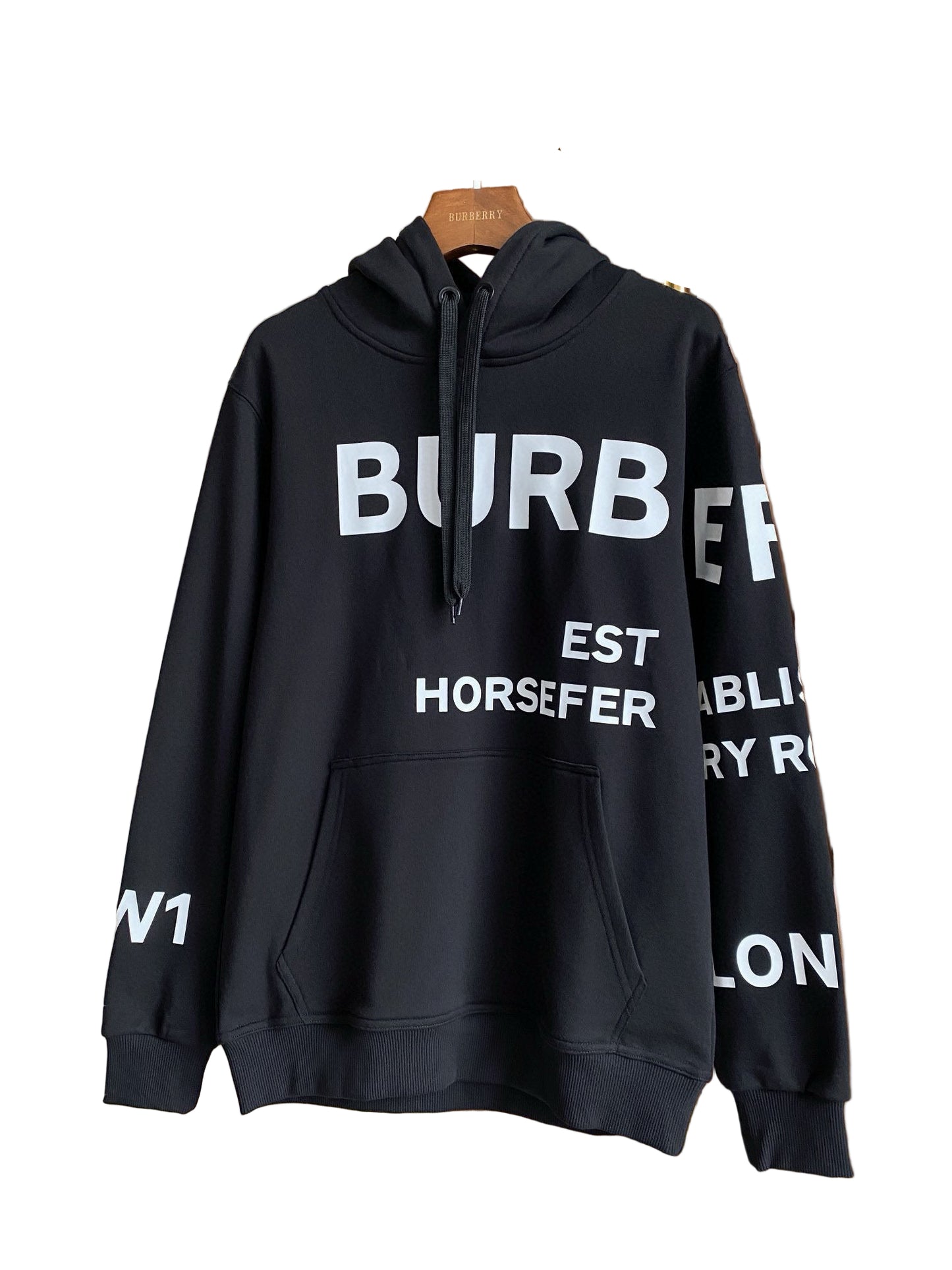 Black hoodie with graphic on a hanger against a neutral background
