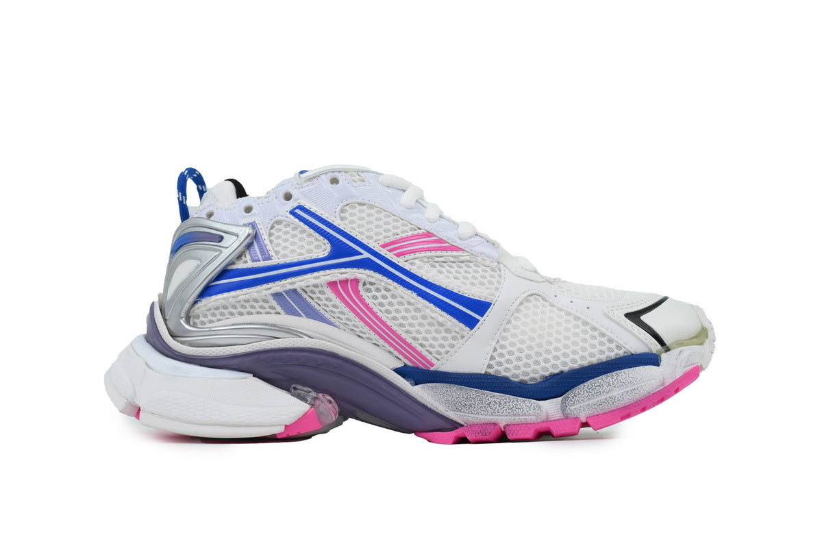 White athletic shoe with blue and pink accents on a white background