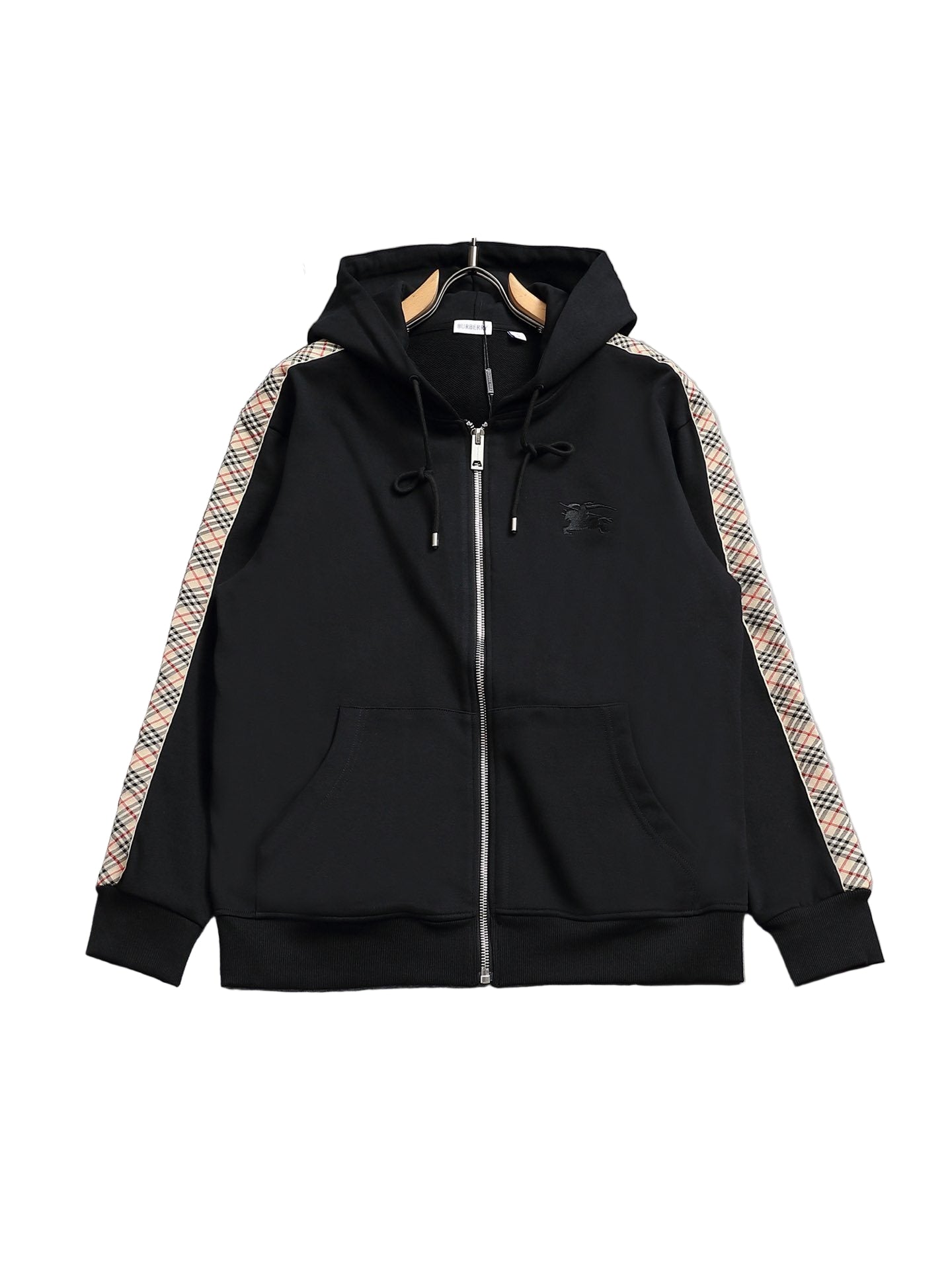 Black hoodie with plaid accents on a gray surface