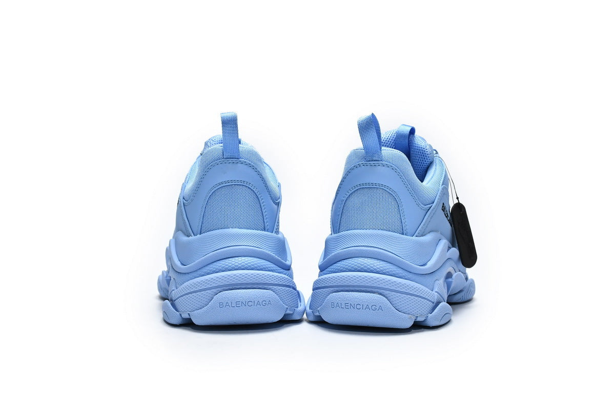 Pair of light blue sneakers on a white background