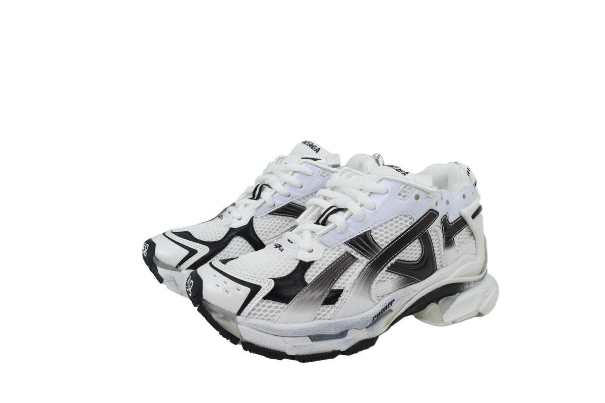 White and black  sneakers with a matching box on a white background