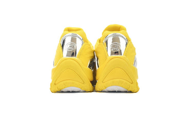 Yellow sneakers with a white sole on a white background