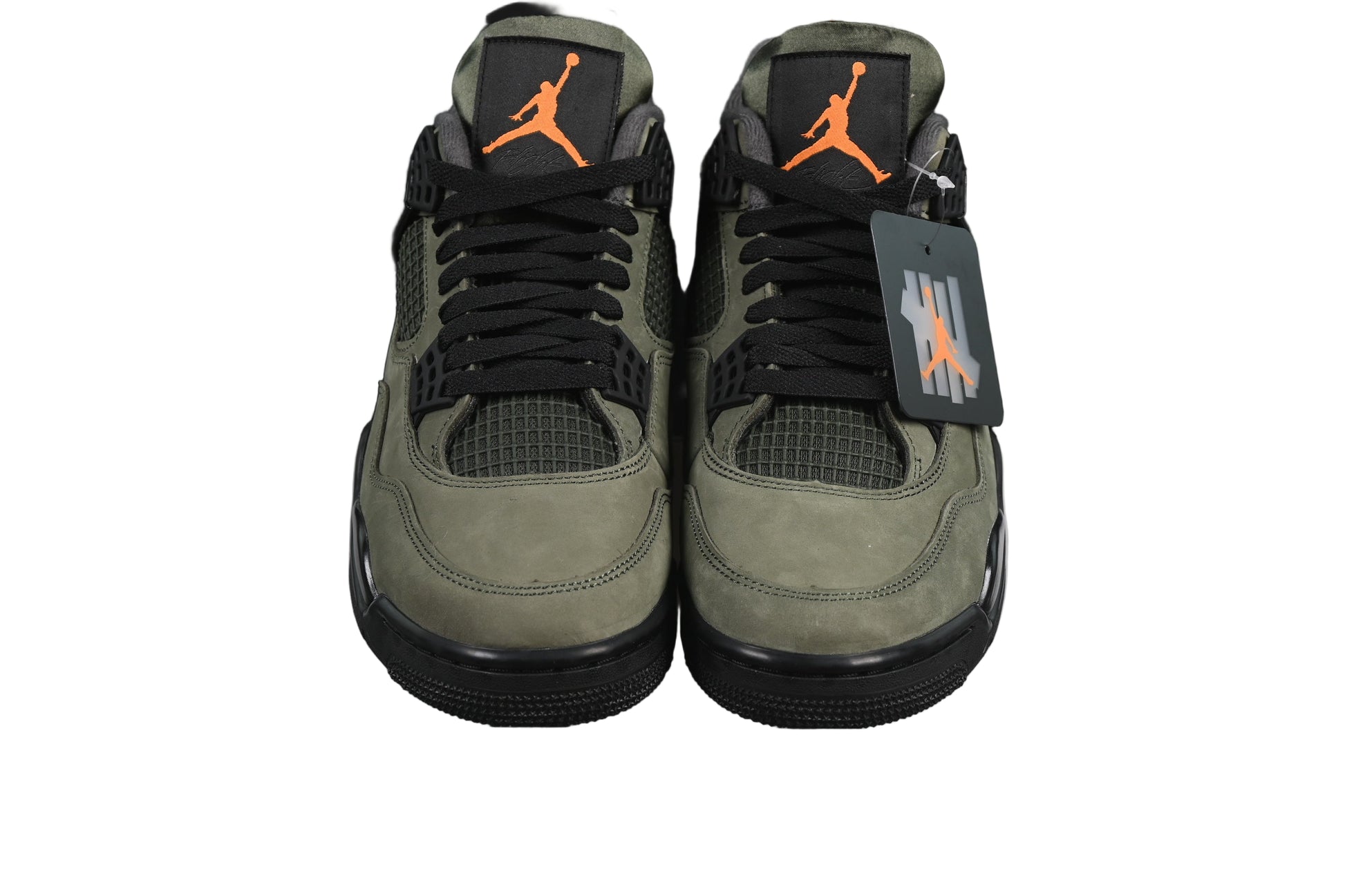Pair of green sneakers with orange l on a black background