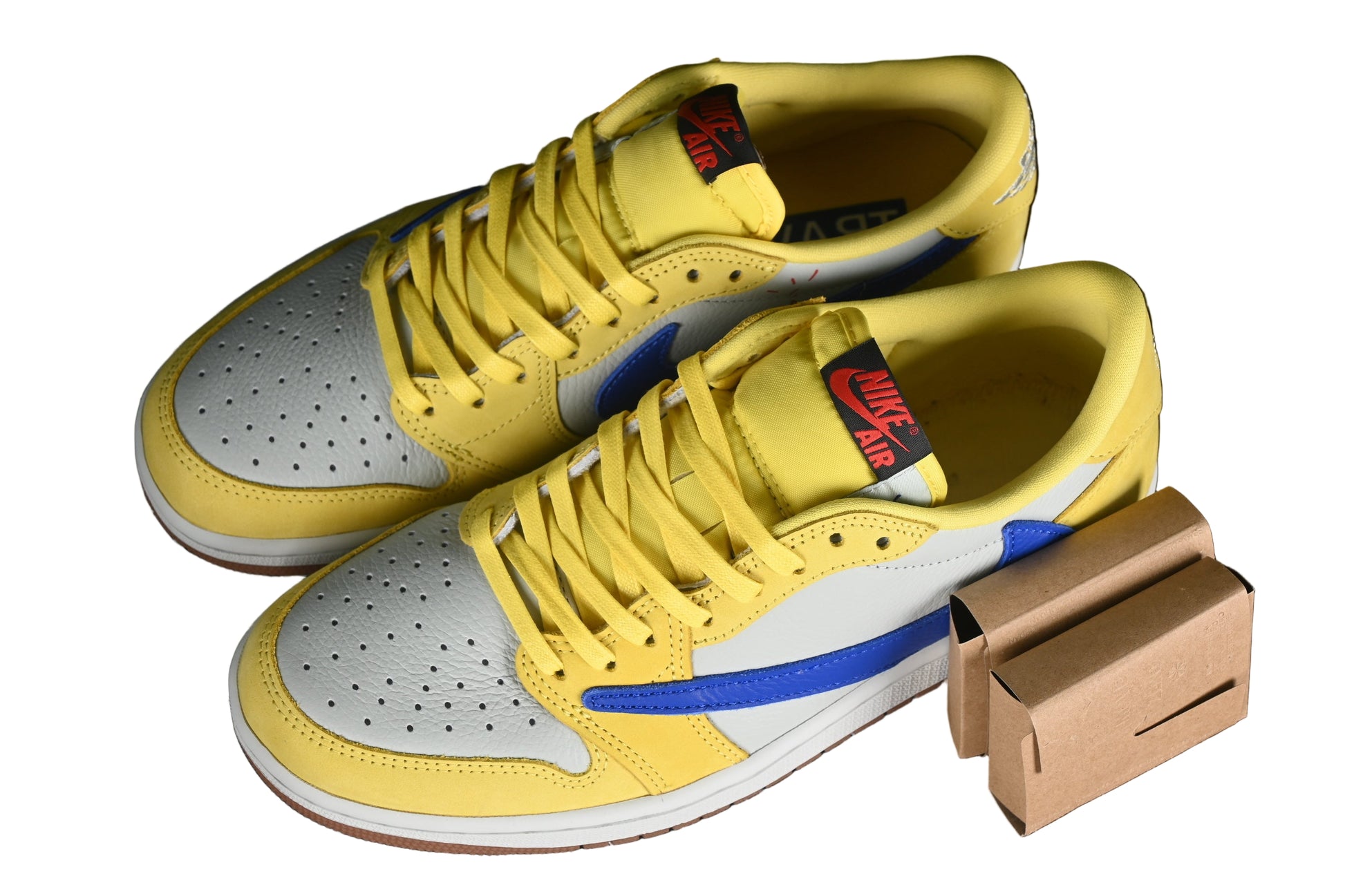 Yellow high-top sneakers with gray soles on a black grid background