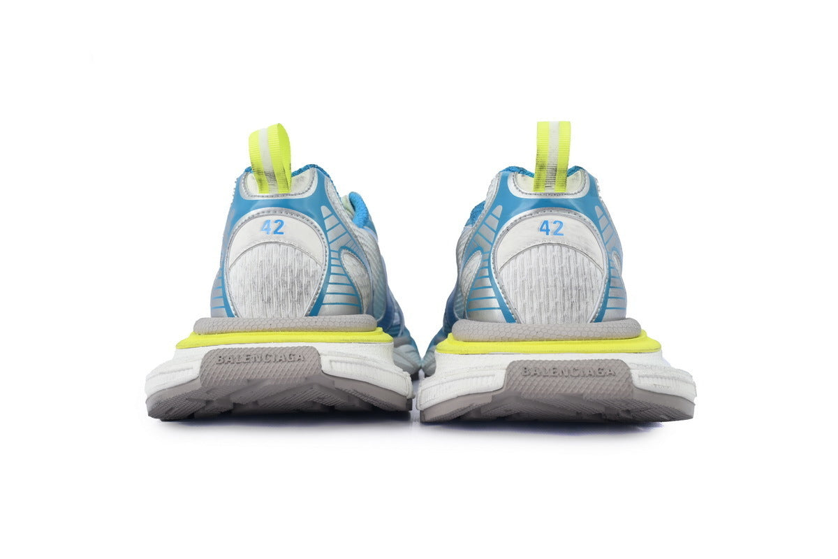 Pair of blue and gray running shoes with yellow accents on a white background