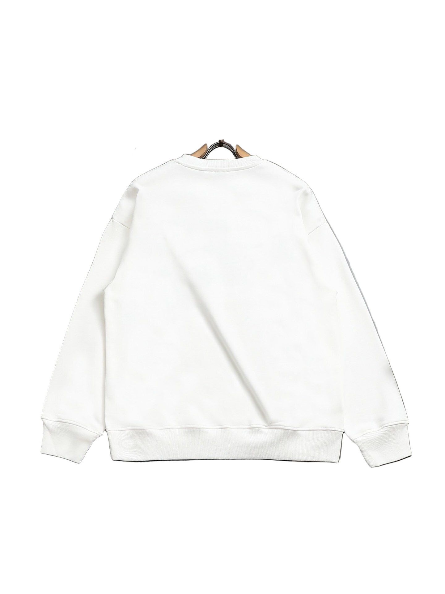 White sweatshirt on a hanger against a gray background