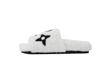 White fuzzy slide sandal with a black star design on a white background