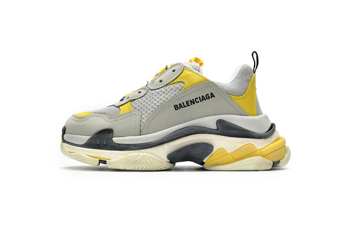  sneaker with gray, yellow, and white design on a white background