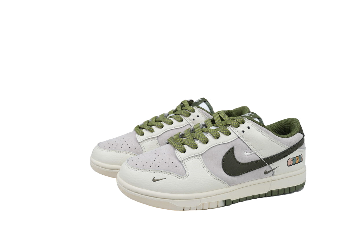 White sneakers with green accents and , displayed in front of a box.