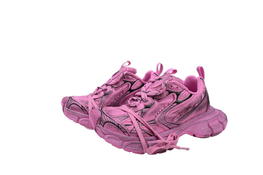 Pink sneakers with a  box in the background