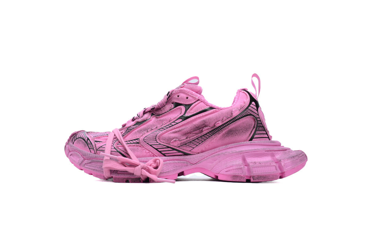 Pink sneaker with black accents on a white background