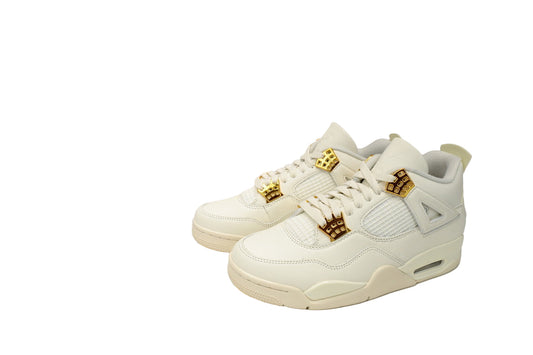 White sneakers with gold accents in front 