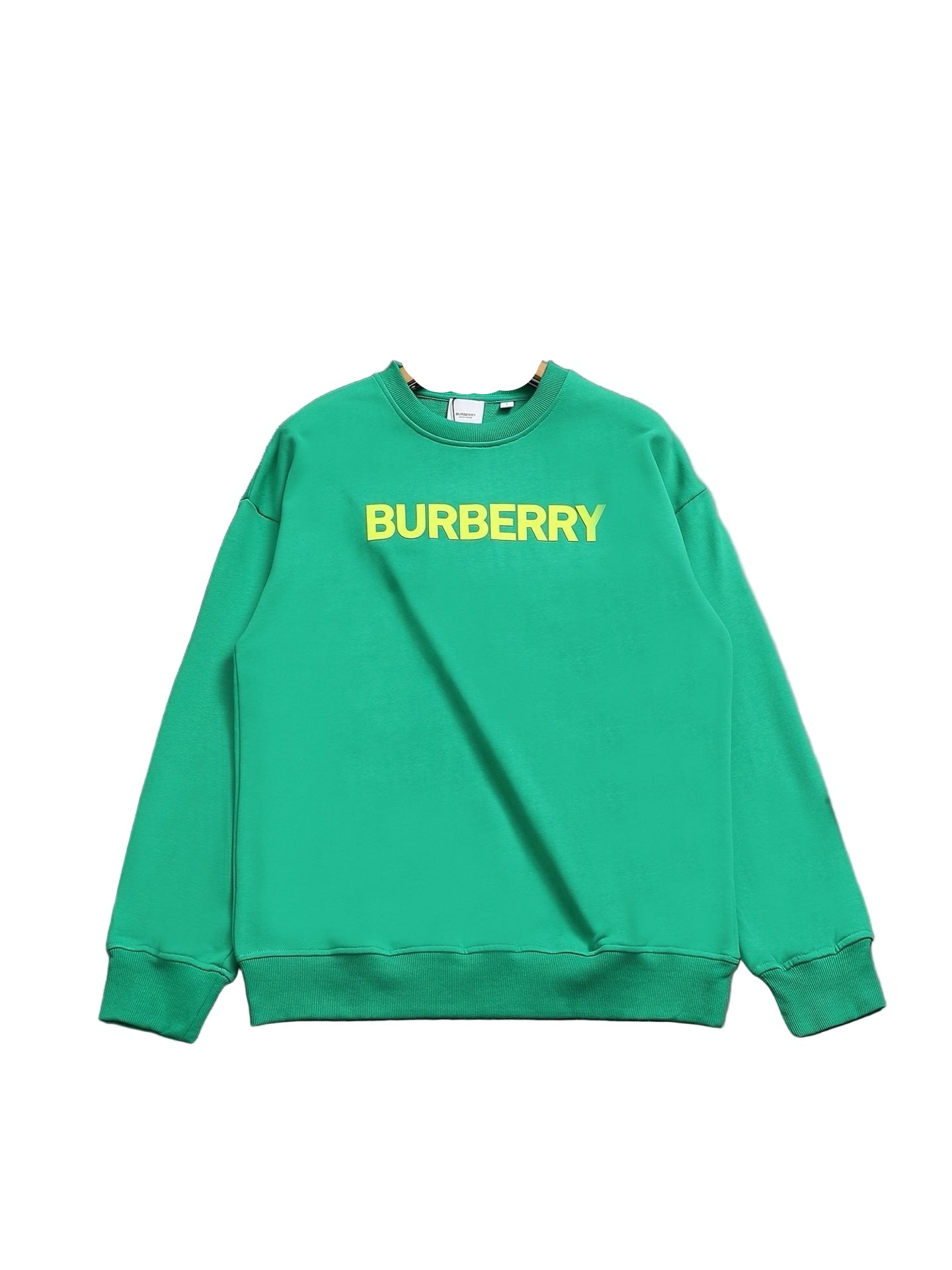 Green sweatshirt on a hanger against a gray background