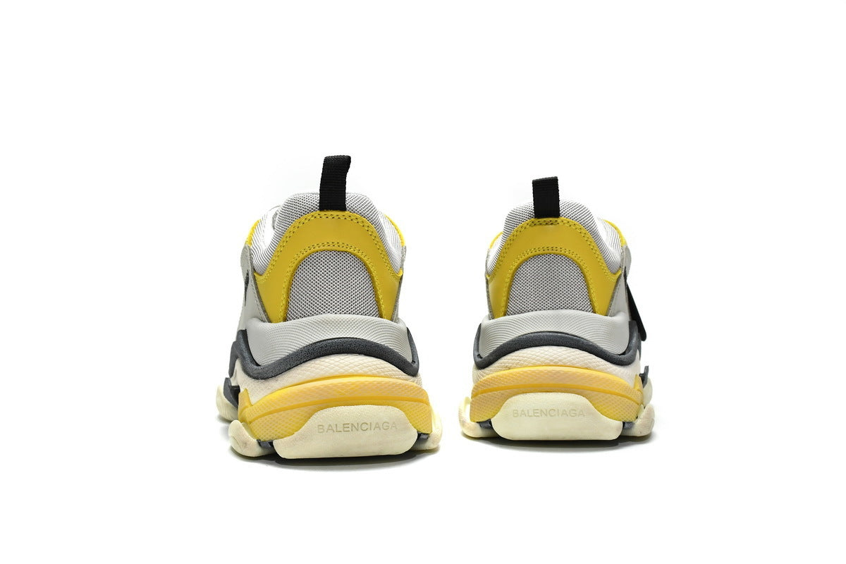 Yellow and gray sneakers on a white background