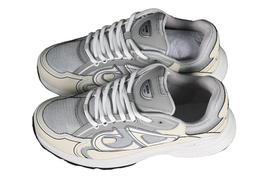 Pair of gray sneakers on a black grid background