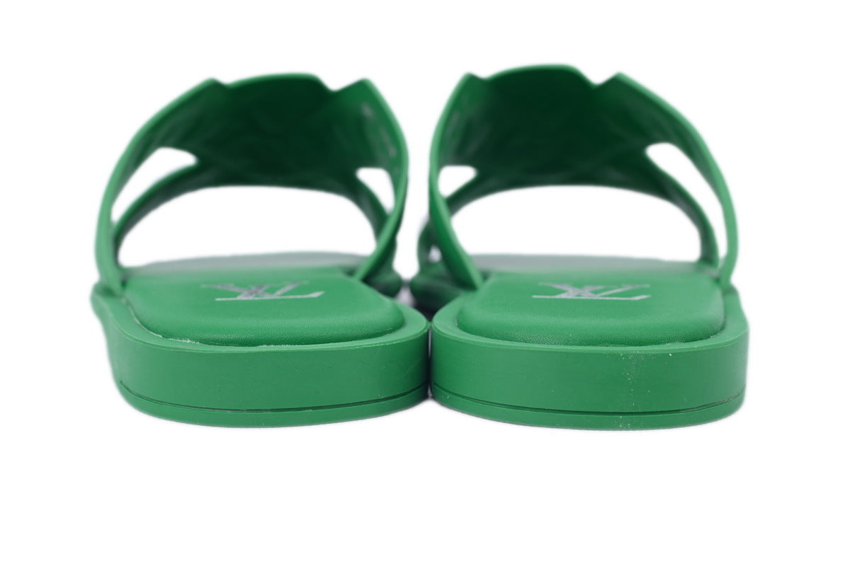 Green sandals with a graphicon a white background