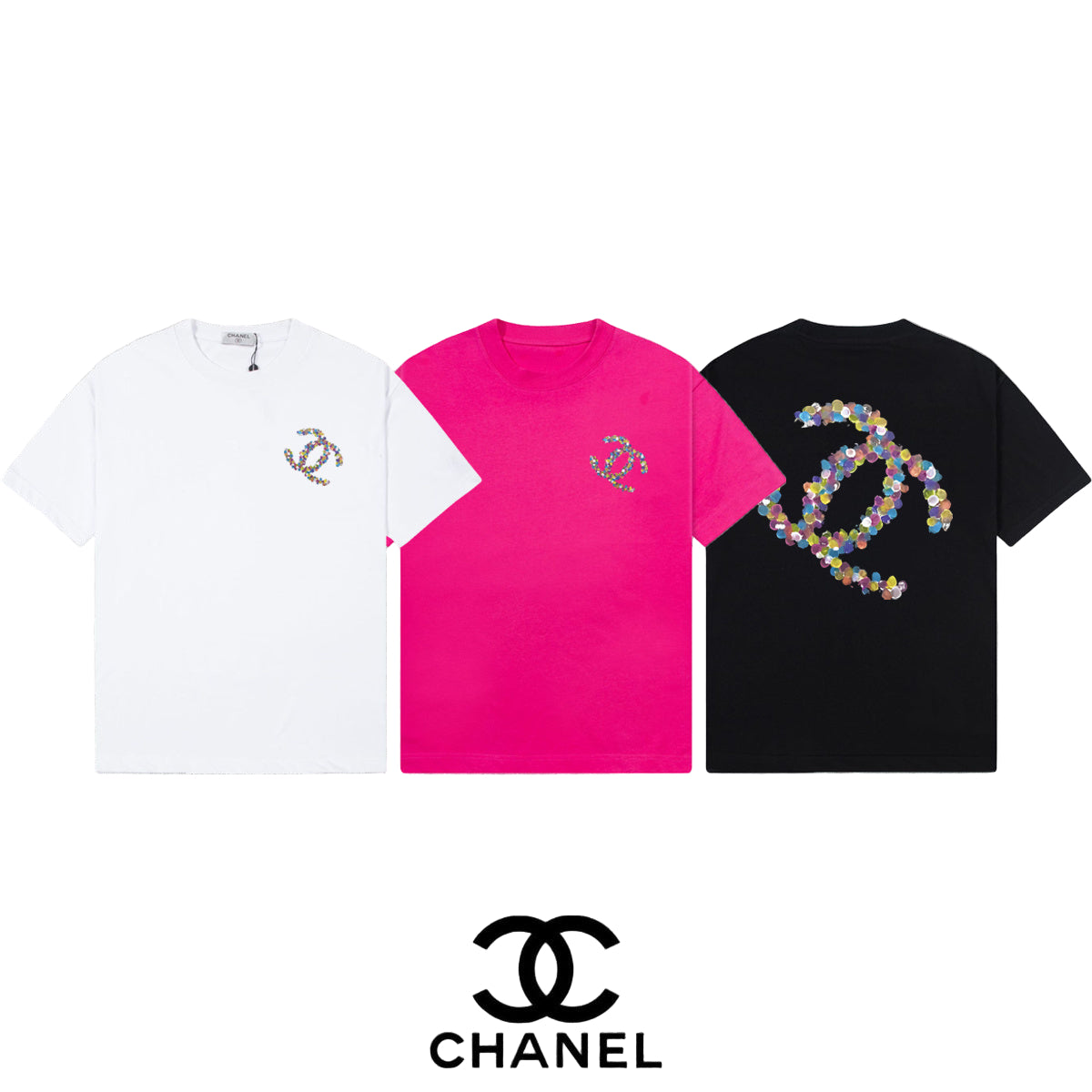 Three  t-shirts in white, pink, and black with floral gra[hicn a gray background.