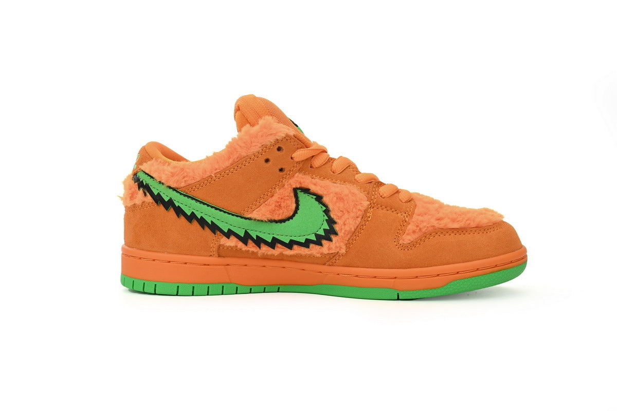 Orange sneaker with green accents on a white background