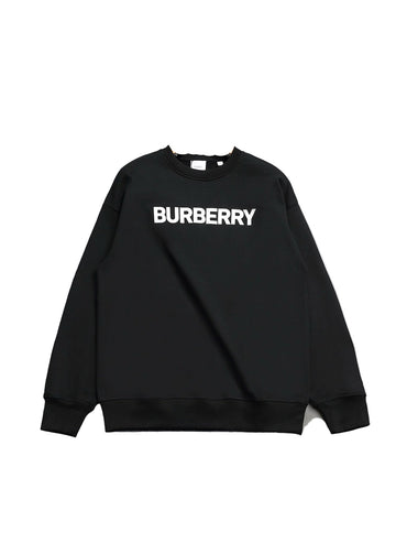 Black sweatshirt on a hanger against a gray background