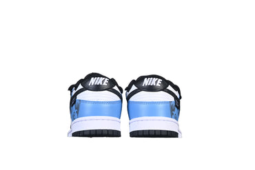 sneakers with black, white, and blue design on a black background