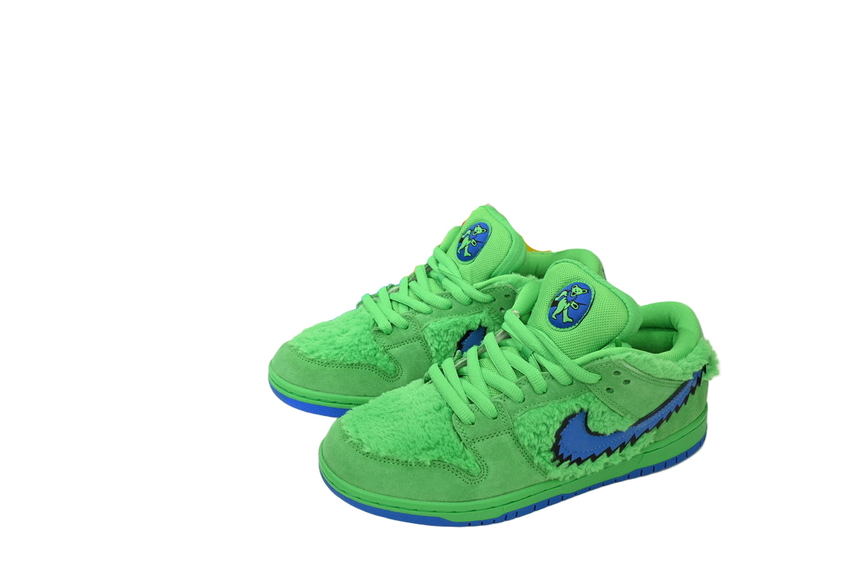 Green sneakers with blue accents next to a colorful box on a white background