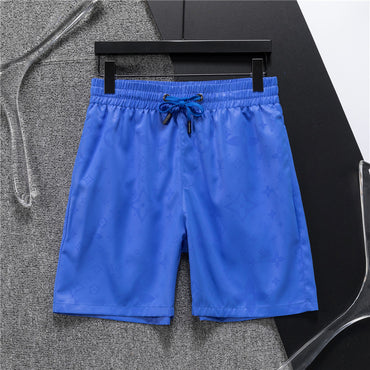 Blue shorts on a hanger against a gray background