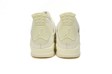 Pair of cream-colored sneakers with agraphic on a white background