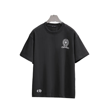 Black t-shirt with a grapjic on a hanger against a textured wall background