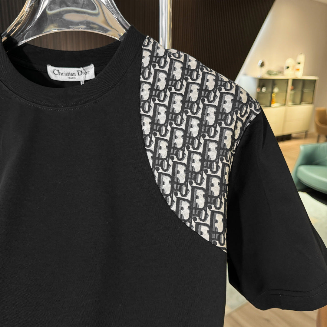 Black shirt with patterned shoulder section on a hanger